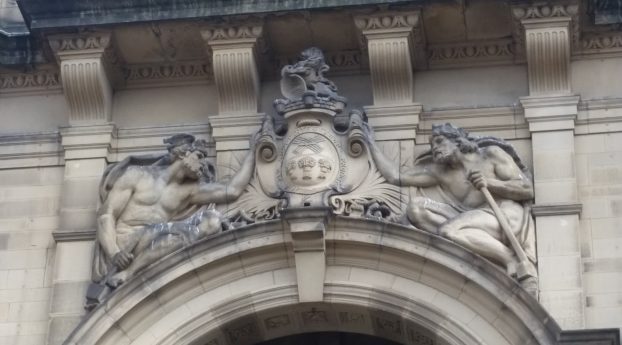 The Roman god Vulcan with his Nordic counterpart Thor over the main doorway of the Town Hall , Sheffield. The sculptor was Frederick W. Pomeroy.